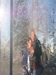 SX25748 Marijn and Jenni reflected in waterfall column Cardiff Bay.jpg